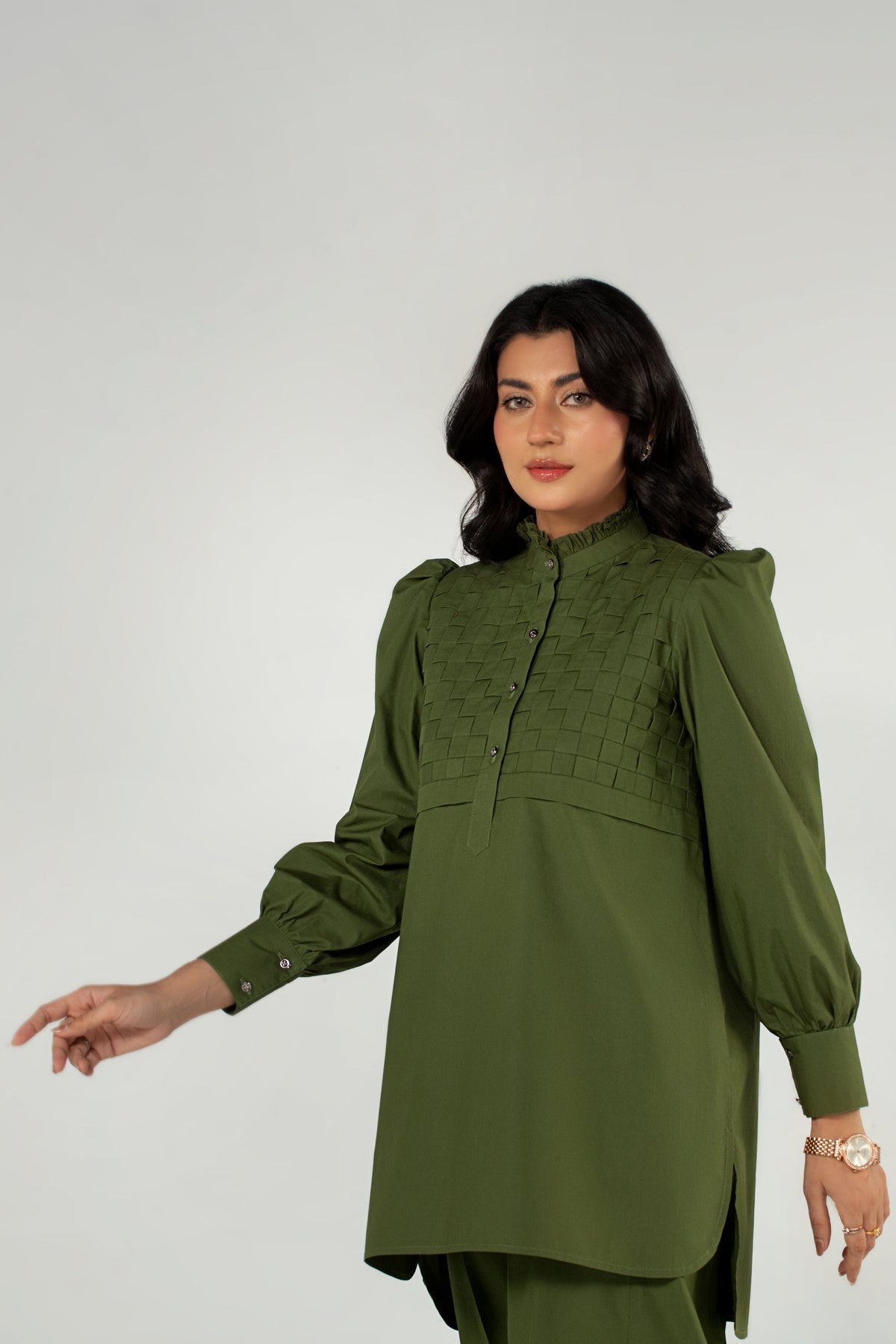 Woman wearing a green dress against a white background