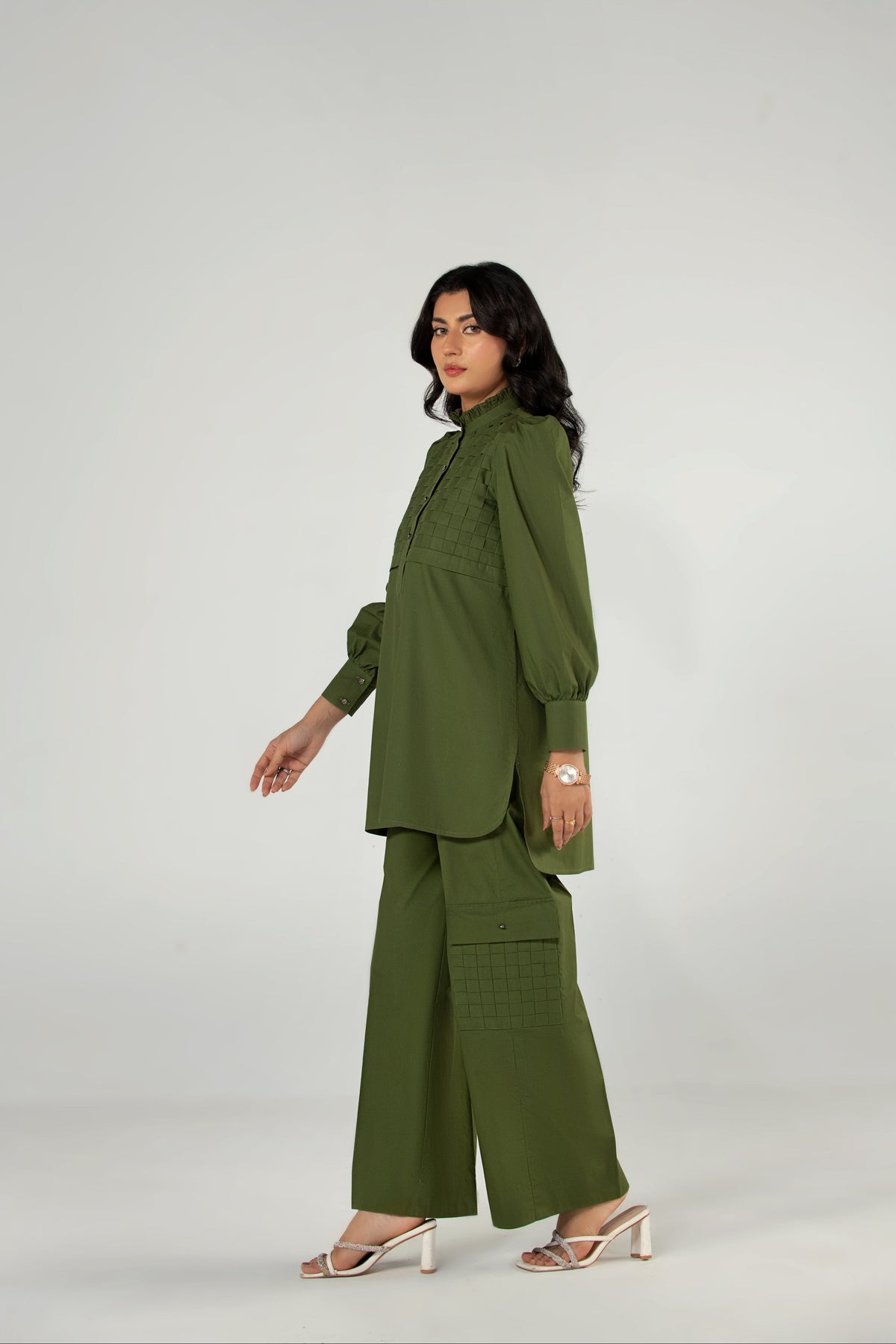 Woman wearing a green outfit on a white background