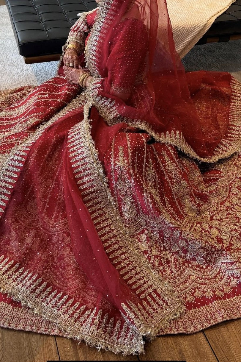 Red and gold patterned fabric on a wooden floor