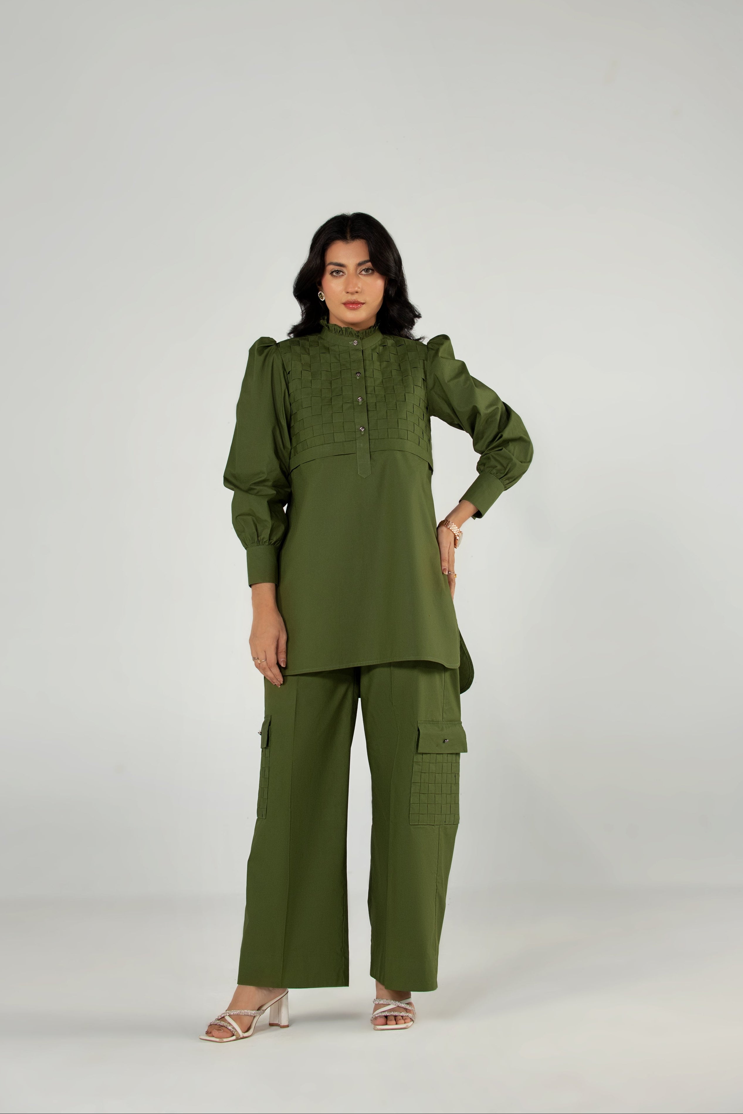 Woman wearing a green outfit on a white background
