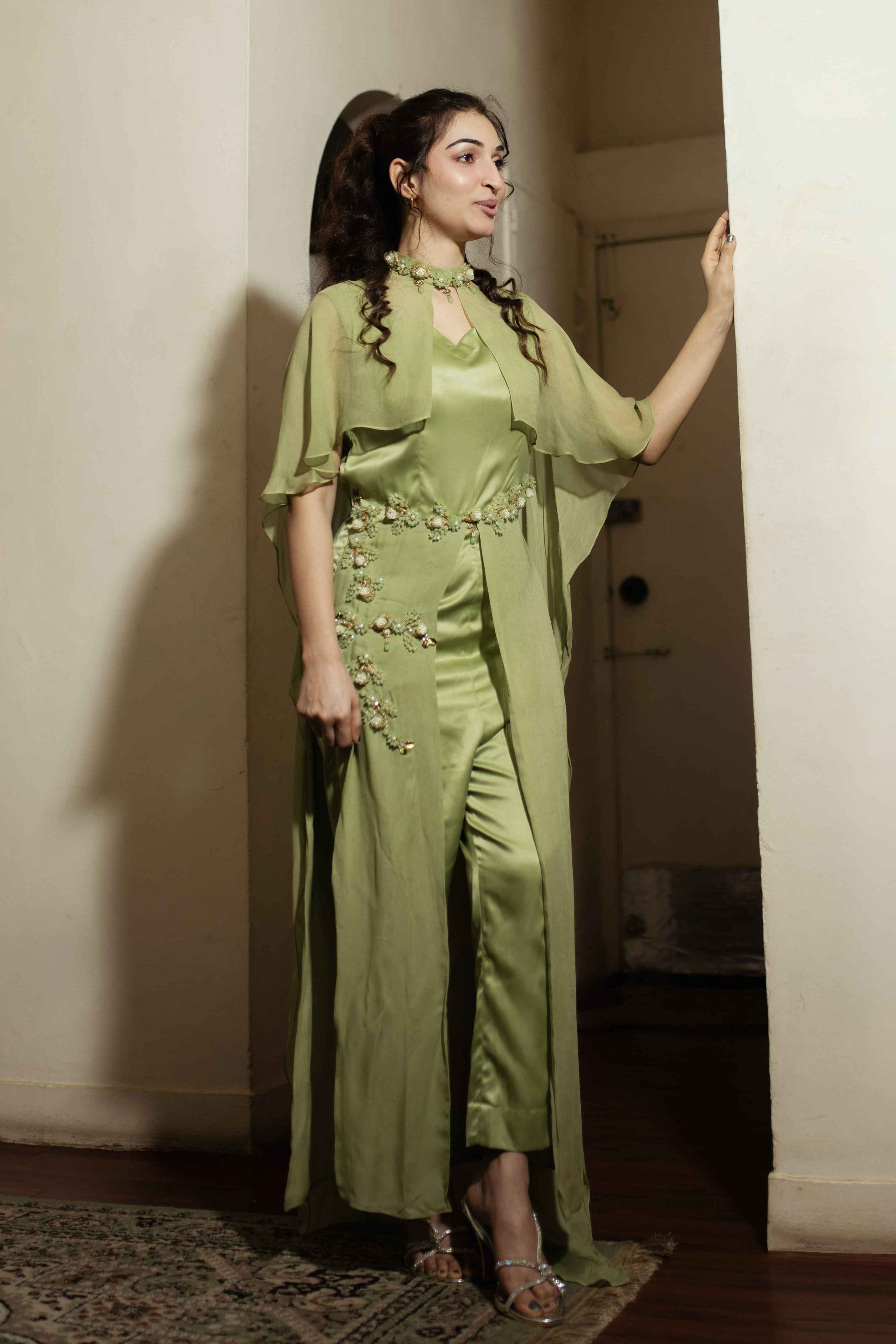Woman in a green dress standing in a doorway